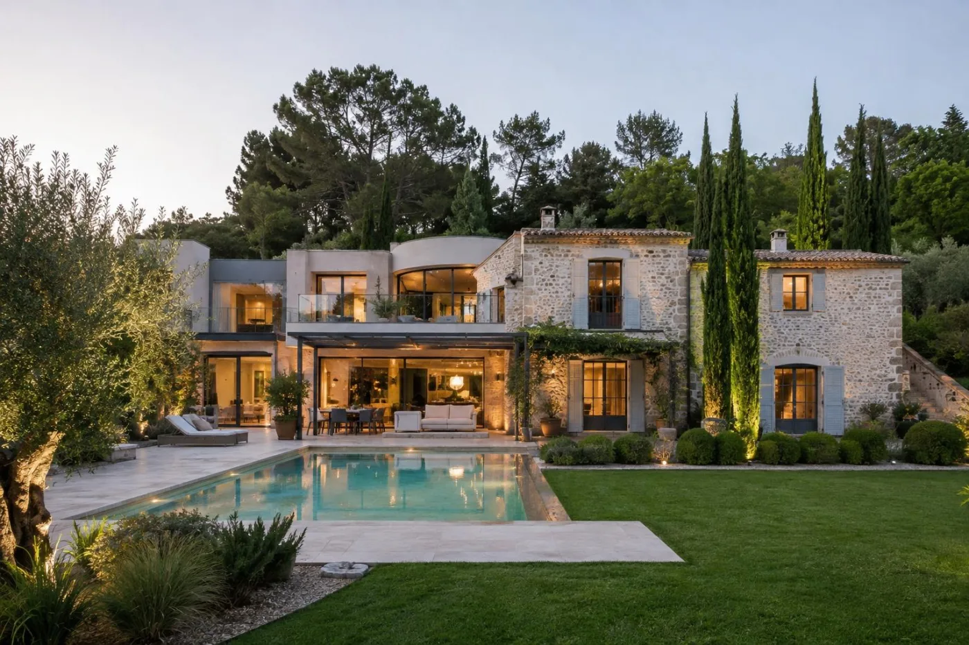 Stone property with a pool and Mediterranean garden in Valbonne at dusk